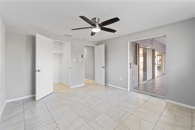 unfurnished bedroom with a textured ceiling, a closet, and ceiling fan