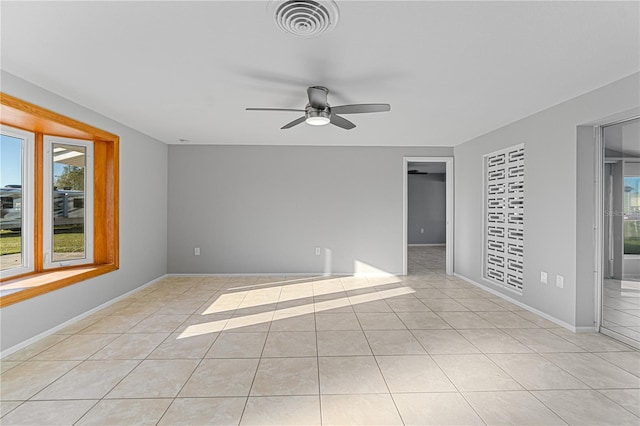 tiled empty room with ceiling fan