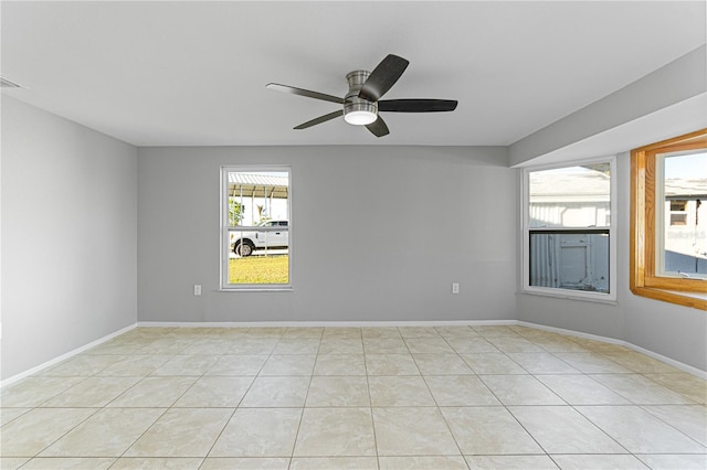 tiled spare room with ceiling fan