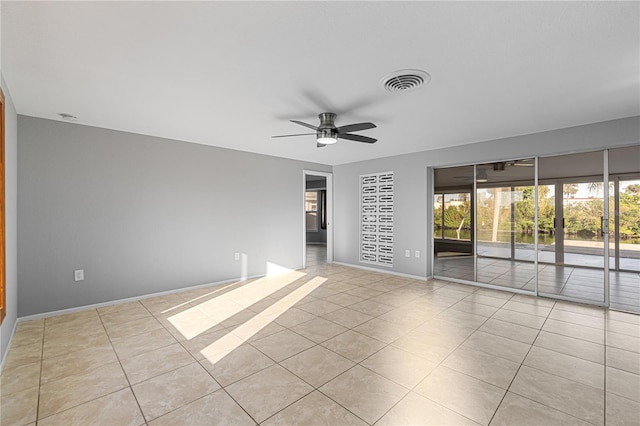 unfurnished room with ceiling fan and light tile patterned floors