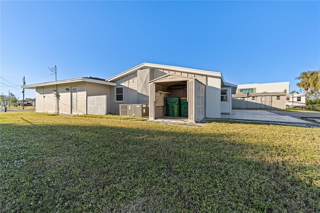 back of house with a lawn