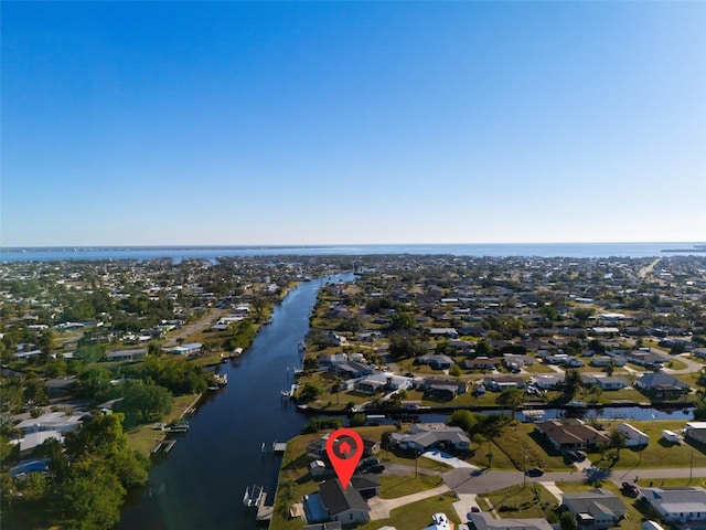 drone / aerial view featuring a residential view and a water view