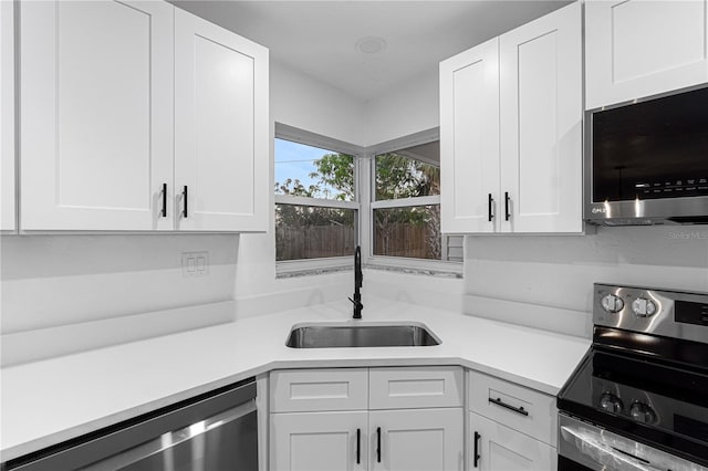 kitchen featuring white cabinets, sink, and stainless steel appliances