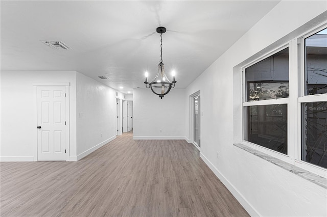 interior space with hardwood / wood-style floors and a notable chandelier