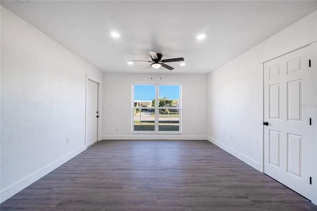 unfurnished room featuring ceiling fan and dark wood-type flooring