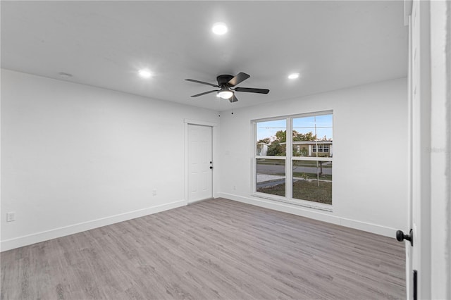 unfurnished room with hardwood / wood-style floors and ceiling fan