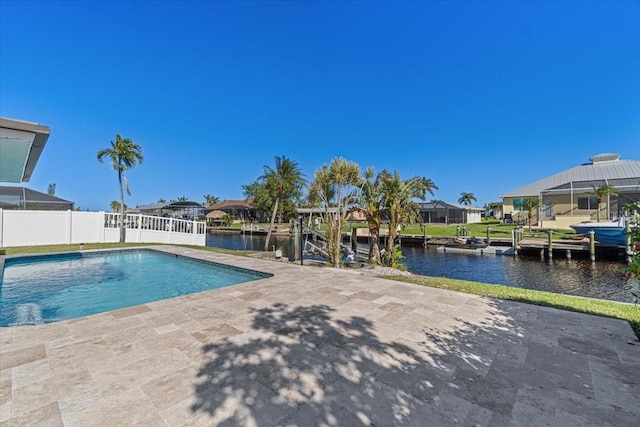 view of pool with a water view, a dock, and a patio area