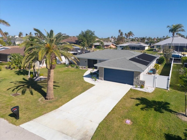 view of front of property with a front yard and a garage