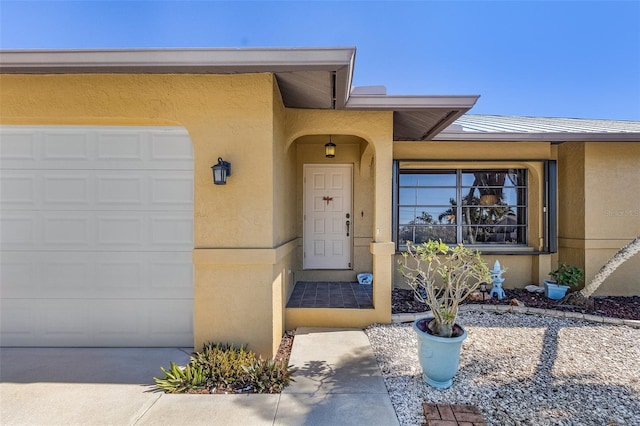 view of exterior entry featuring a garage