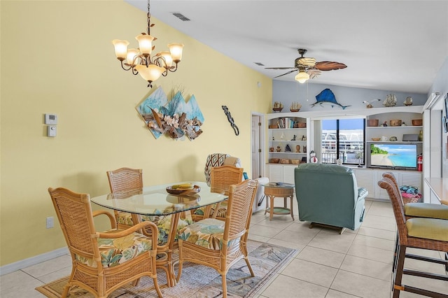 tiled dining space featuring ceiling fan with notable chandelier and lofted ceiling