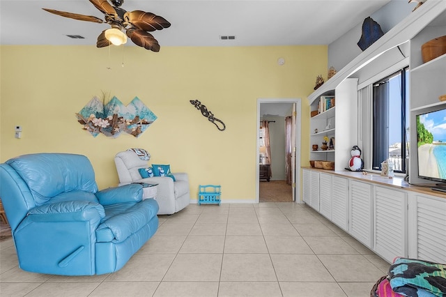 sitting room featuring ceiling fan and light tile patterned flooring