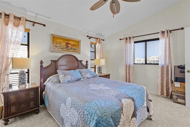 bedroom with ceiling fan, light carpet, and vaulted ceiling