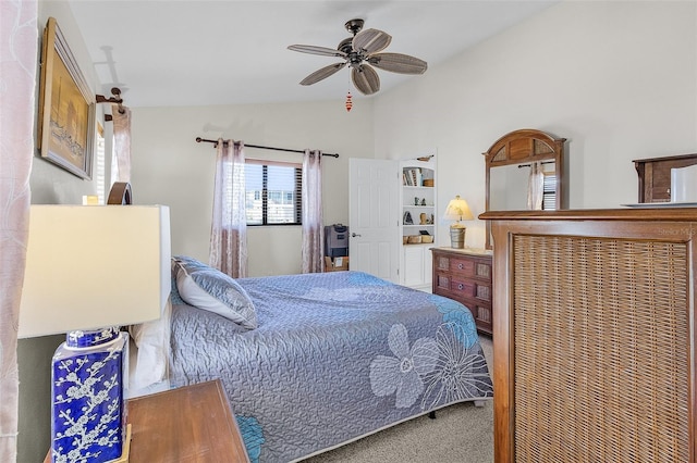 carpeted bedroom with vaulted ceiling and ceiling fan