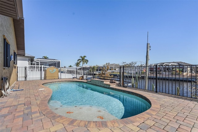 view of swimming pool featuring a patio area and a water view