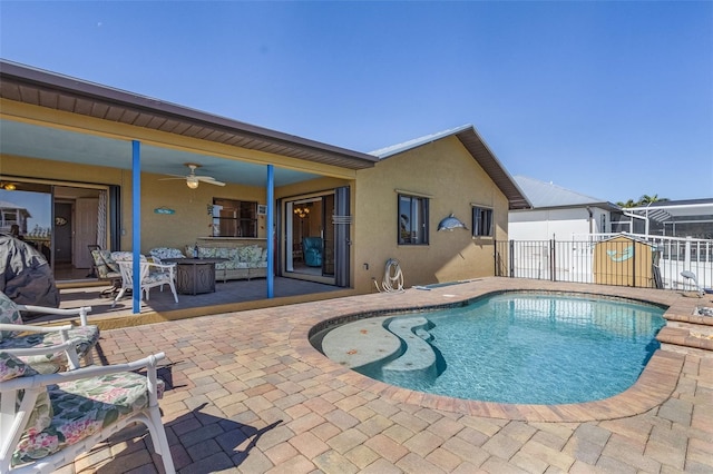 view of swimming pool with ceiling fan and a patio