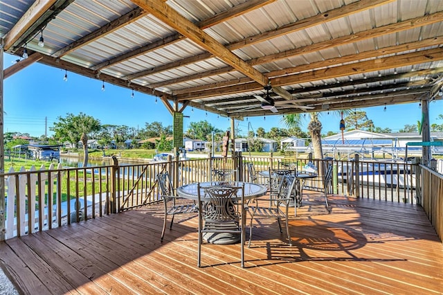824 E 6th St, Englewood, FL 34223 - wooden terrace featuring outdoor dining area and a water view