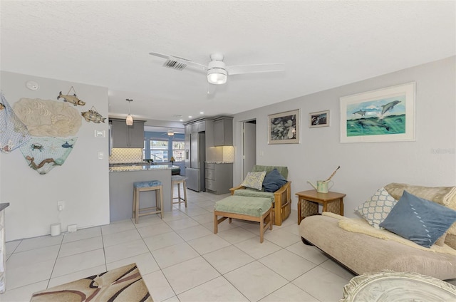 824 E 6th St, Englewood, FL 34223 - living room with ceiling fan and light tile patterned floors