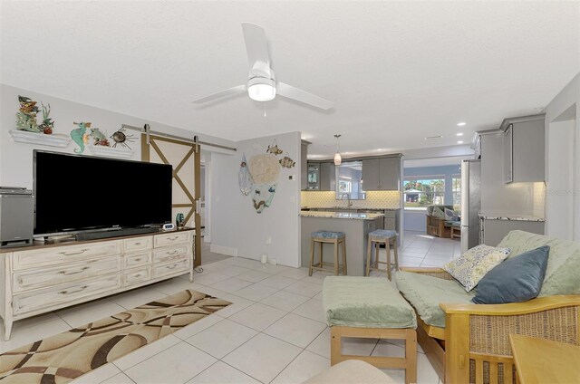 824 E 6th St, Englewood, FL 34223 - living area with light tile patterned floors and ceiling fan