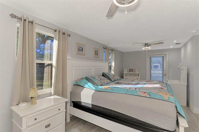 bedroom with a textured ceiling and ceiling fan