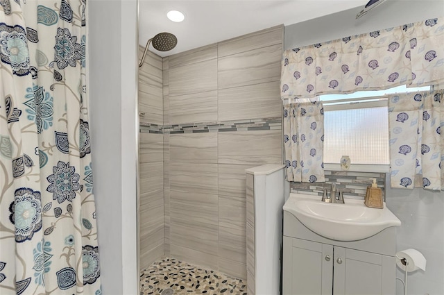 824 E 6th St, Englewood, FL 34223 - bathroom with tiled shower, vanity, decorative backsplash, and recessed lighting