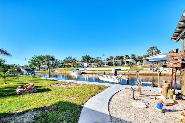 824 E 6th St, Englewood, FL 34223 - view of community featuring a yard, a water view, and a dock