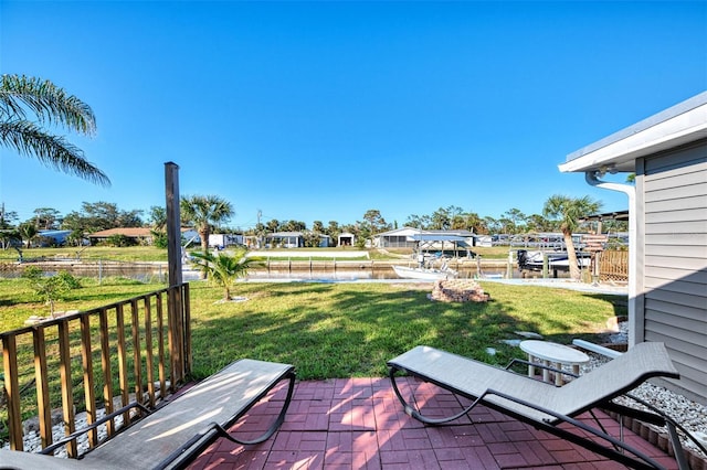 824 E 6th St, Englewood, FL 34223 - view of green lawn featuring a water view and a patio
