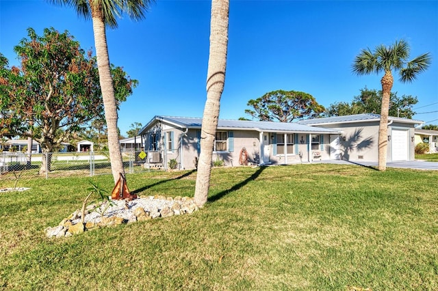 824 E 6th St, Englewood, FL 34223 - view of front of property featuring a garage, a metal roof, and concrete driveway