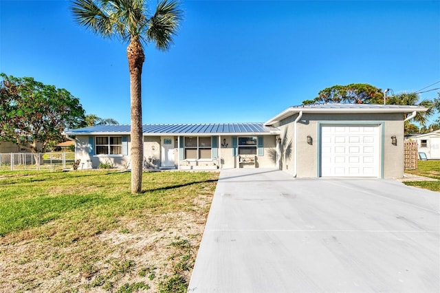 824 E 6th St, Englewood, FL 34223 - single story home with an attached garage, concrete driveway, stucco siding, and a metal roof