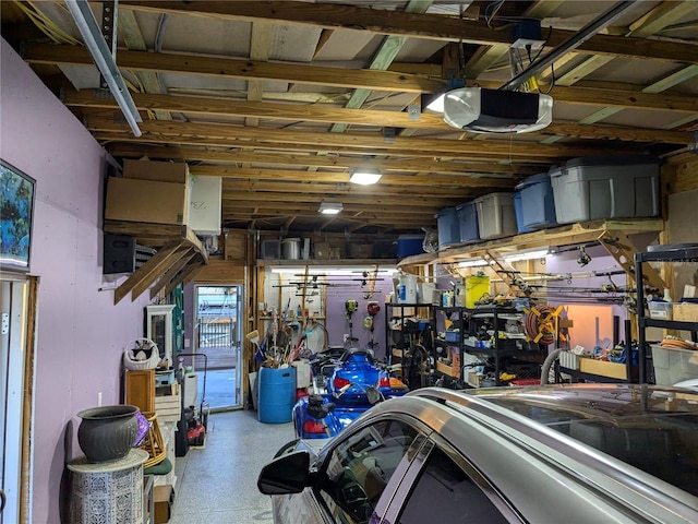 garage with a workshop area and a garage door opener