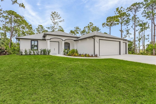 view of front of property with a front yard and a garage