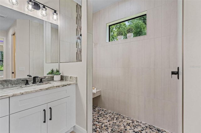 bathroom featuring vanity and a shower