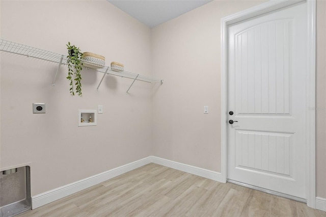 laundry area featuring electric dryer hookup, hookup for a washing machine, and light hardwood / wood-style floors