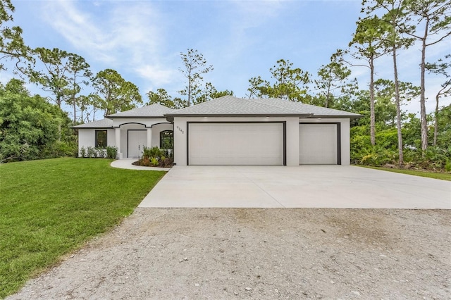 view of front of property featuring a front lawn and a garage