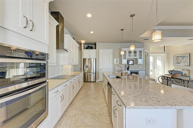 kitchen featuring a large island, sink, white cabinets, and stainless steel appliances