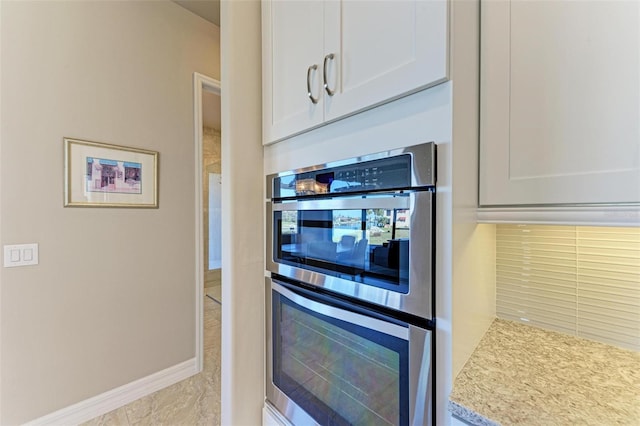 kitchen featuring white cabinetry and stainless steel double oven