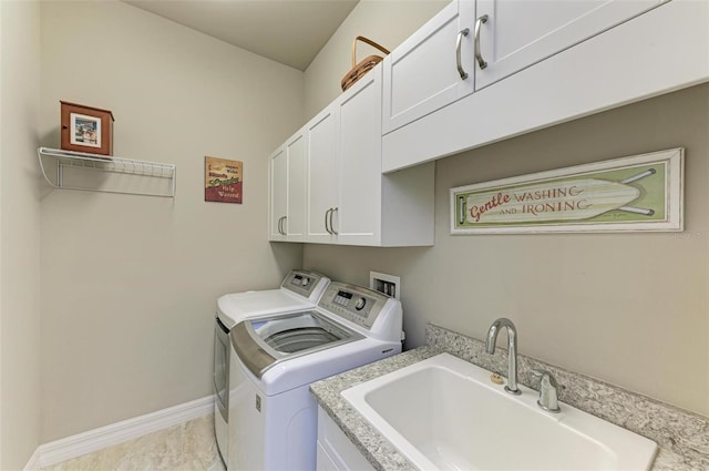 clothes washing area with cabinets, independent washer and dryer, and sink