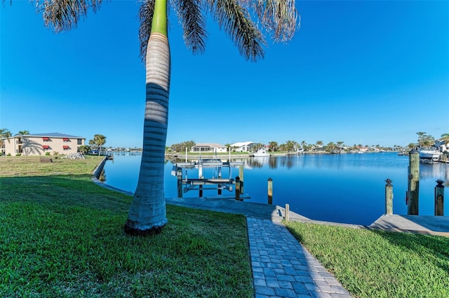 dock area featuring a yard and a water view