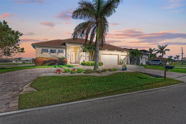 view of front of property with a lawn and a garage