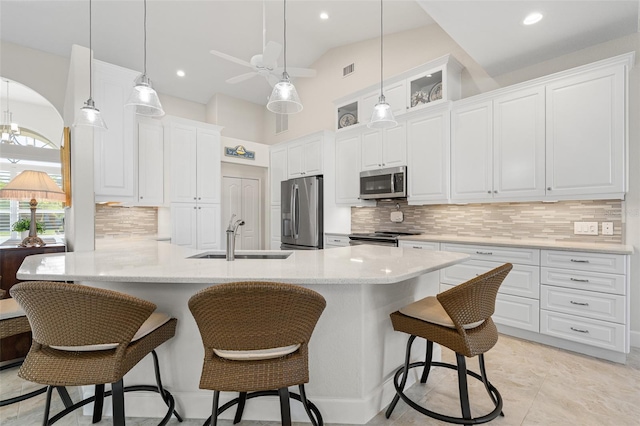 kitchen with white cabinets, sink, ceiling fan, decorative backsplash, and appliances with stainless steel finishes