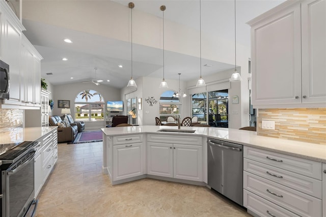 kitchen with pendant lighting, white cabinets, decorative backsplash, ceiling fan, and appliances with stainless steel finishes