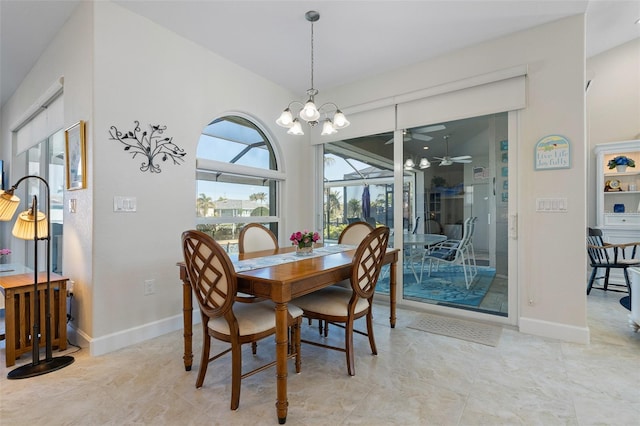 dining area featuring ceiling fan with notable chandelier