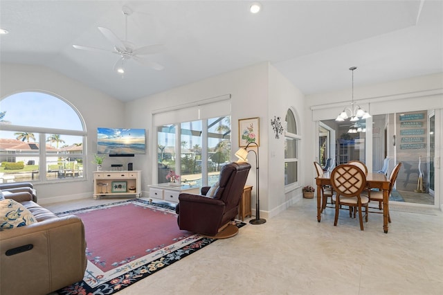 living room featuring ceiling fan with notable chandelier and lofted ceiling