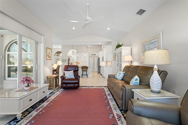 living room with ceiling fan and lofted ceiling