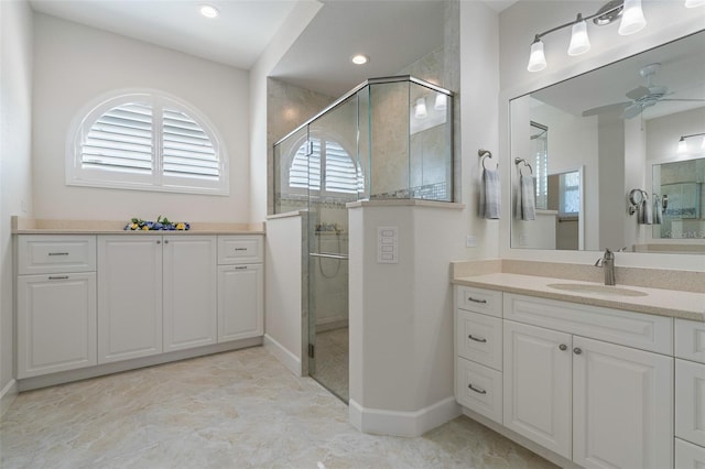 bathroom with ceiling fan, walk in shower, and vanity