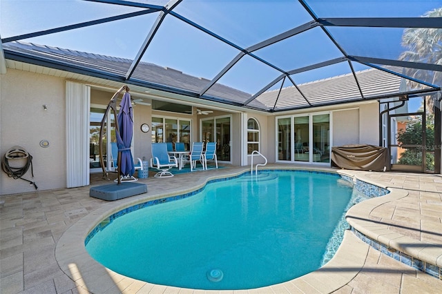 view of swimming pool with a lanai, ceiling fan, and a patio