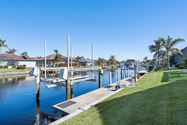 dock area featuring a water view and a yard