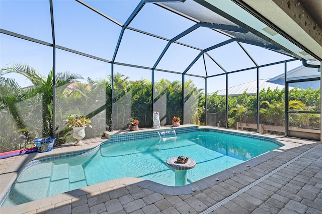 view of swimming pool featuring a patio, pool water feature, and glass enclosure