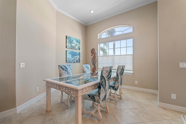 dining room with light tile patterned floors and crown molding