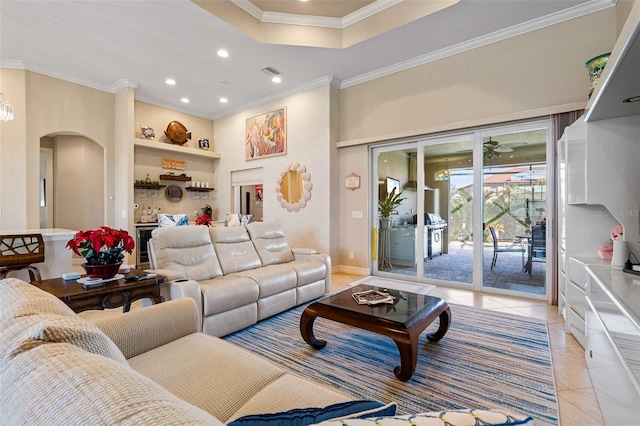 living room with ceiling fan, light tile patterned floors, and crown molding