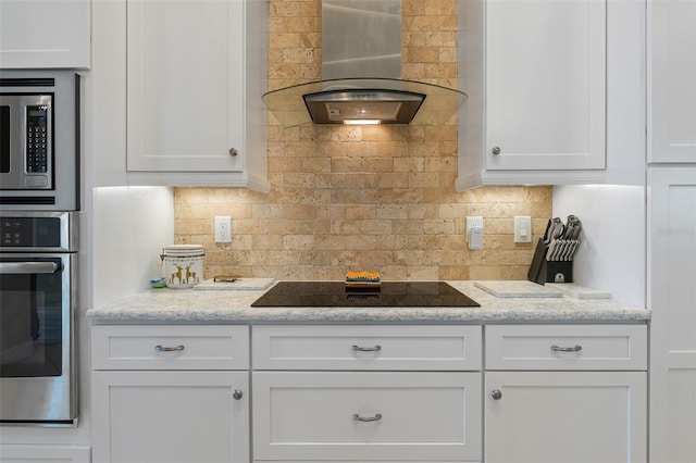 kitchen with white cabinets, stainless steel appliances, and ventilation hood